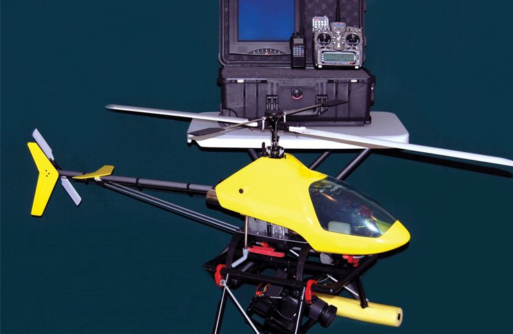 A rotary unmanned aerial system (UAS) comprises of the helicopter UAV, or flight vehicle; the ground station; and the communication or data links.