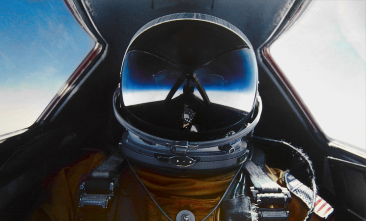 A self-portrait of Brian Shul in full flight suit gear within the cockpit of the SR-71 Blackbird.