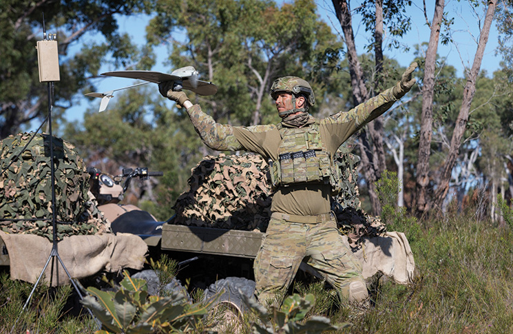 Australian Army soldier, Lance Bombardier Jarrod Logan, prepares to launch the Wasp unmanned aerial system during a training activity at the Wide Bay Training Area