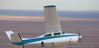 Image of a Cessna 210 aircraft flying