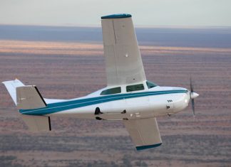 Image of a Cessna 210 aircraft flying