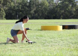 Woman preparing to fly a drone.