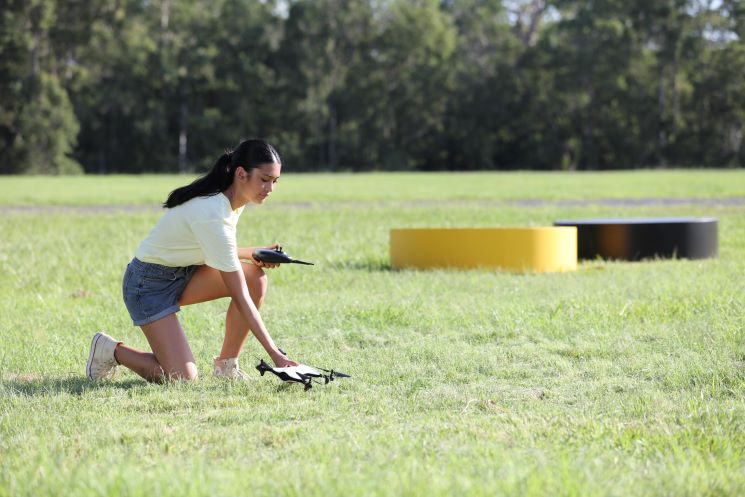 Woman preparing to fly a drone.