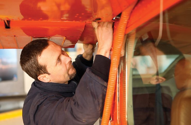 Engineer working on the wing of a Cessna