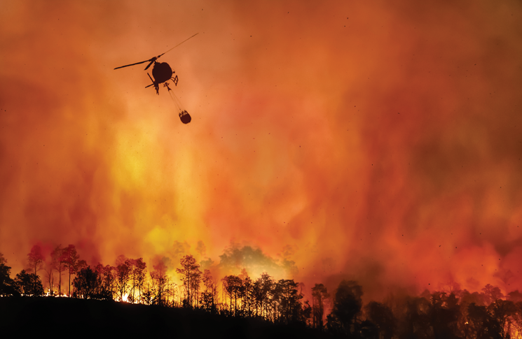 Helicopter water bomber fighting a bushfire