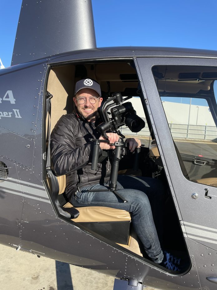Production Company Owner, Corey Roberts filming from a helicopter in the early days of his career.