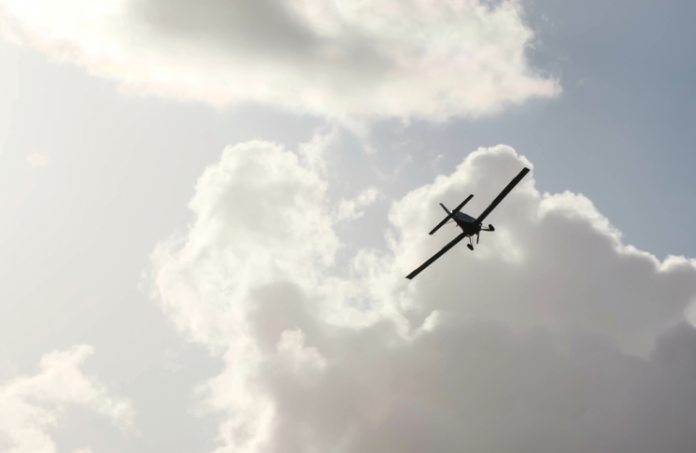 Small plane flying in a cloudy sky