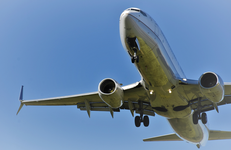 Close up of a section of a Boeing aircraft on a blue sky background