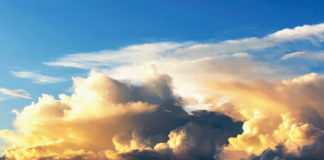 Image of blue sky with storm clouds forming