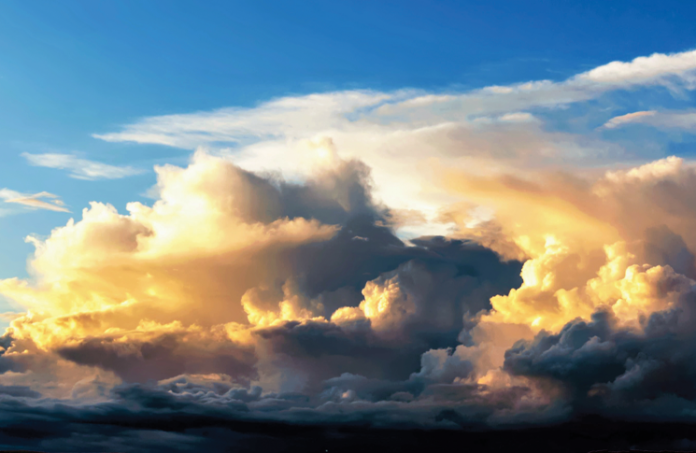 Image of blue sky with storm clouds forming