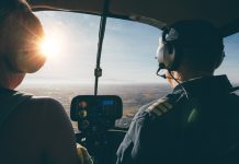 Image of two pilots flying a helicopter