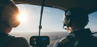 Image of two pilots flying a helicopter