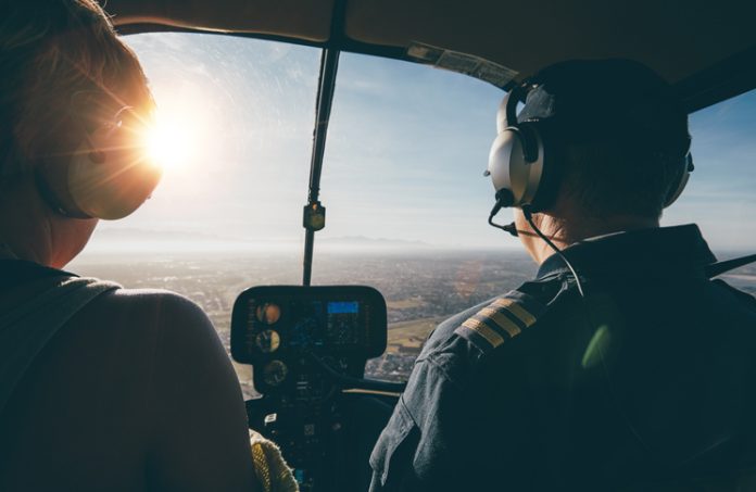Image of two pilots flying a helicopter