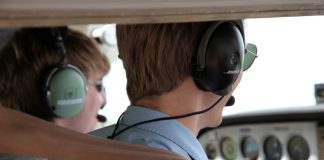Flight training instructor and student in the cockpit of a light aircraft