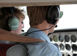 Flight training instructor and student in the cockpit of a light aircraft