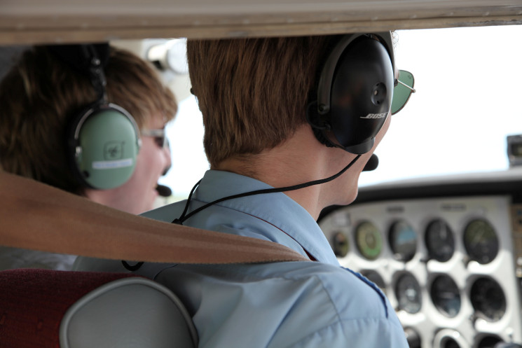 Flight training instructor and student in the cockpit of a light aircraft