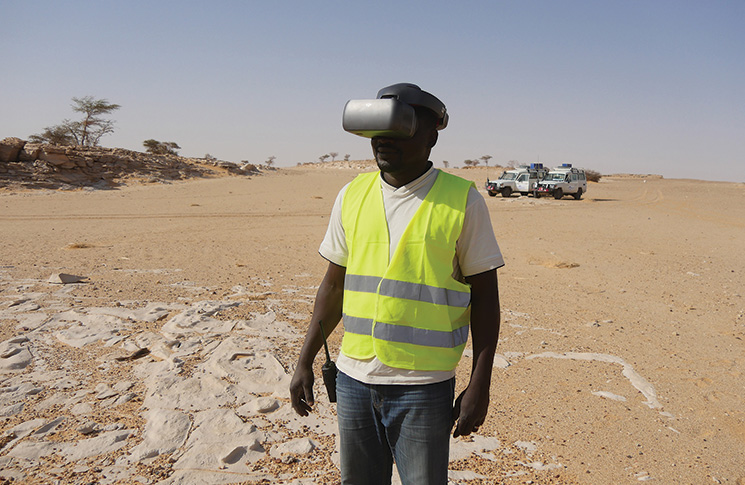 Teamwork using drone technology in the Sahara Desert during inspection flights where the explosive ordnance disposal expert had an immersive, live view of hazards through video goggles.