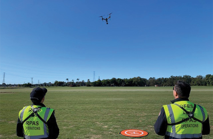 Drone operators from QFES flying a drone