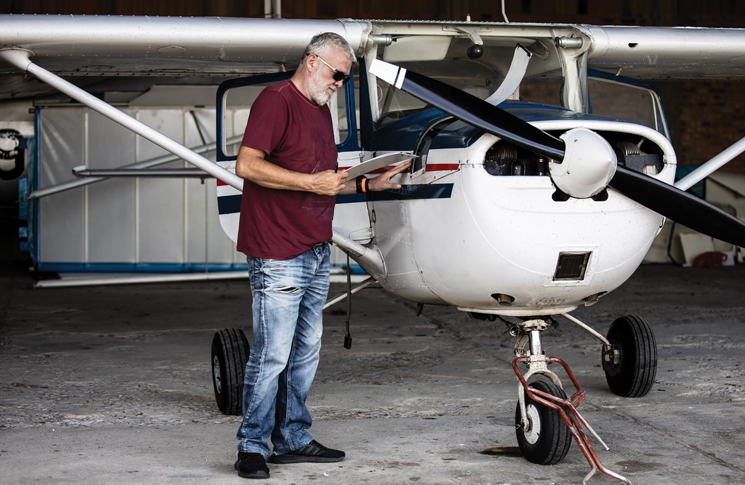 image of a man checking an aircraft check list after maintenance