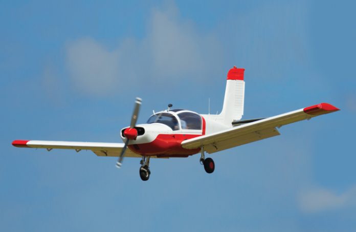 small aircraft flying in blue sky