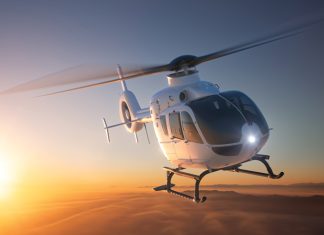 Helicopter flying with sunset in the background