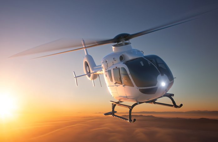 Helicopter flying with sunset in the background