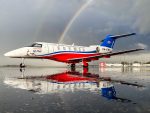Photo by Joel Baverstock. Royal Flying Doctor Service PC-24 parked on wet tarmac at Perth International Airport.