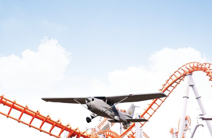 photo compilation of small aircraft flying low past a rollercoaster