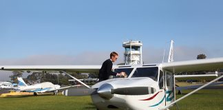 Pilot cleaning the windshield of an aircraft