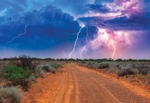 Summertime, daytime lightning storm over an outback road