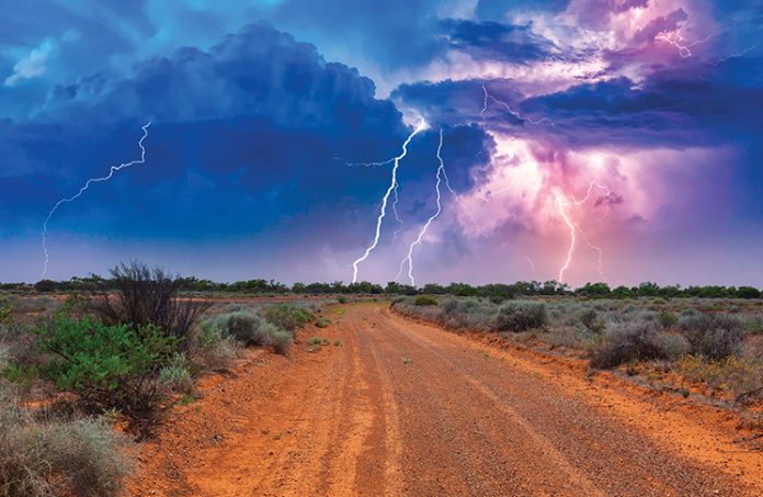 Summertime, daytime lightning storm over an outback road