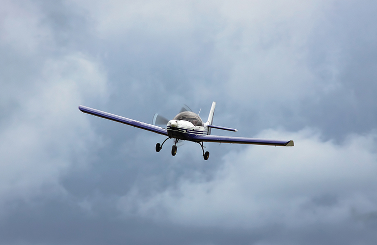 aircraft flying in a cloudy sky