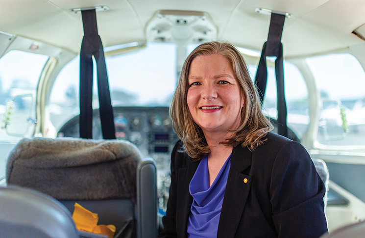 Portrait of Adrianne Fleming sitting inside a small aircraft