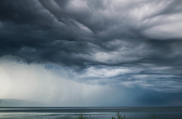 low clouds and rain above the ocean.