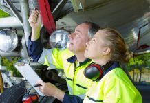 Airport ground crew check an aircraft.