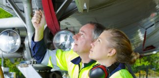 Airport ground crew check an aircraft.