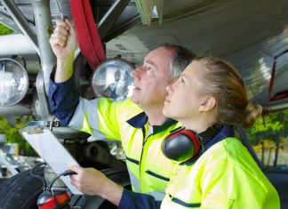 Airport ground crew check an aircraft.