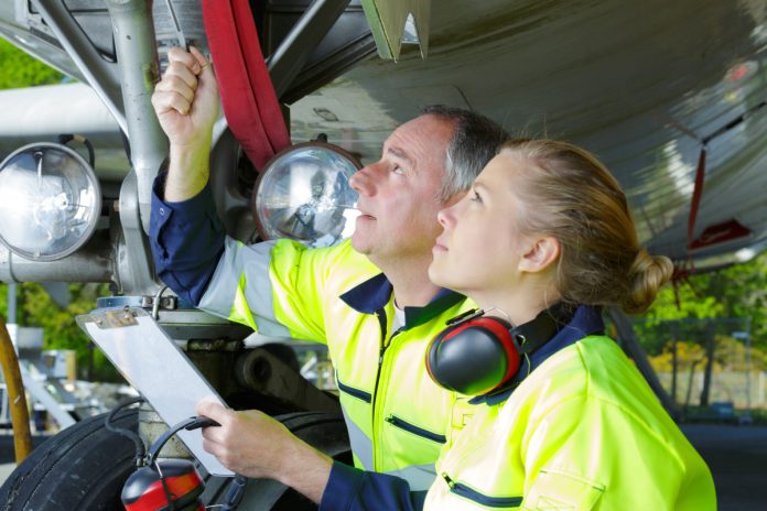 Airport ground crew check an aircraft.