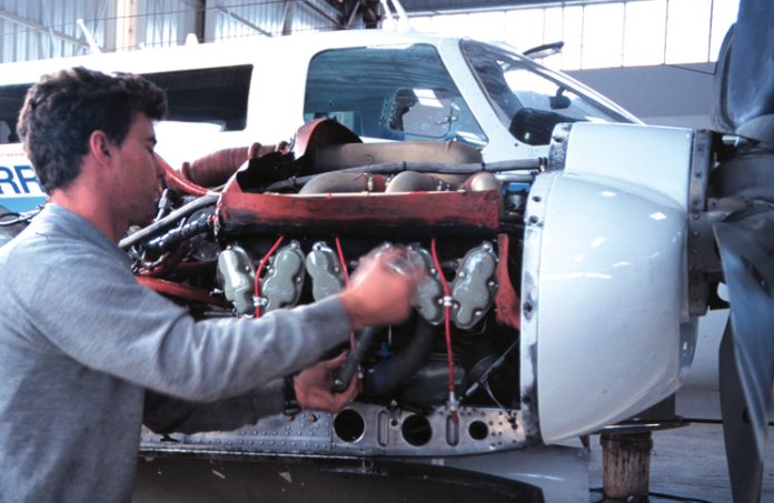 Aircraft engineer working on an engine.
