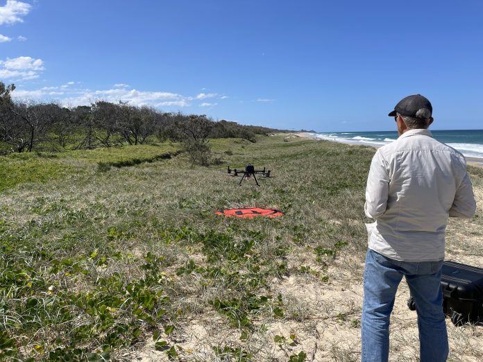 Peter from Aspect UAV flying the drone along the beach