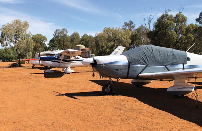 Photo of small aircraft parked on the red earth at Corynnia Station.