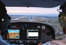 Photo from inside a cockpit of an aircraft approaching a runway