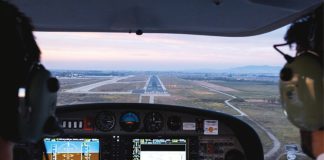 Photo from inside a cockpit of an aircraft approaching a runway