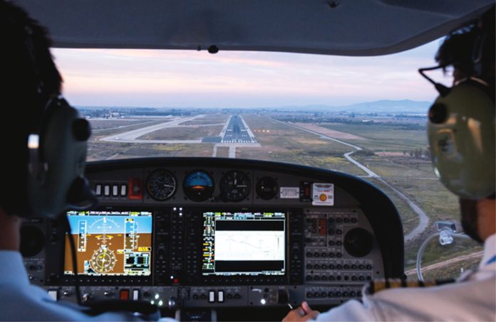 Photo from inside a cockpit of an aircraft approaching a runway