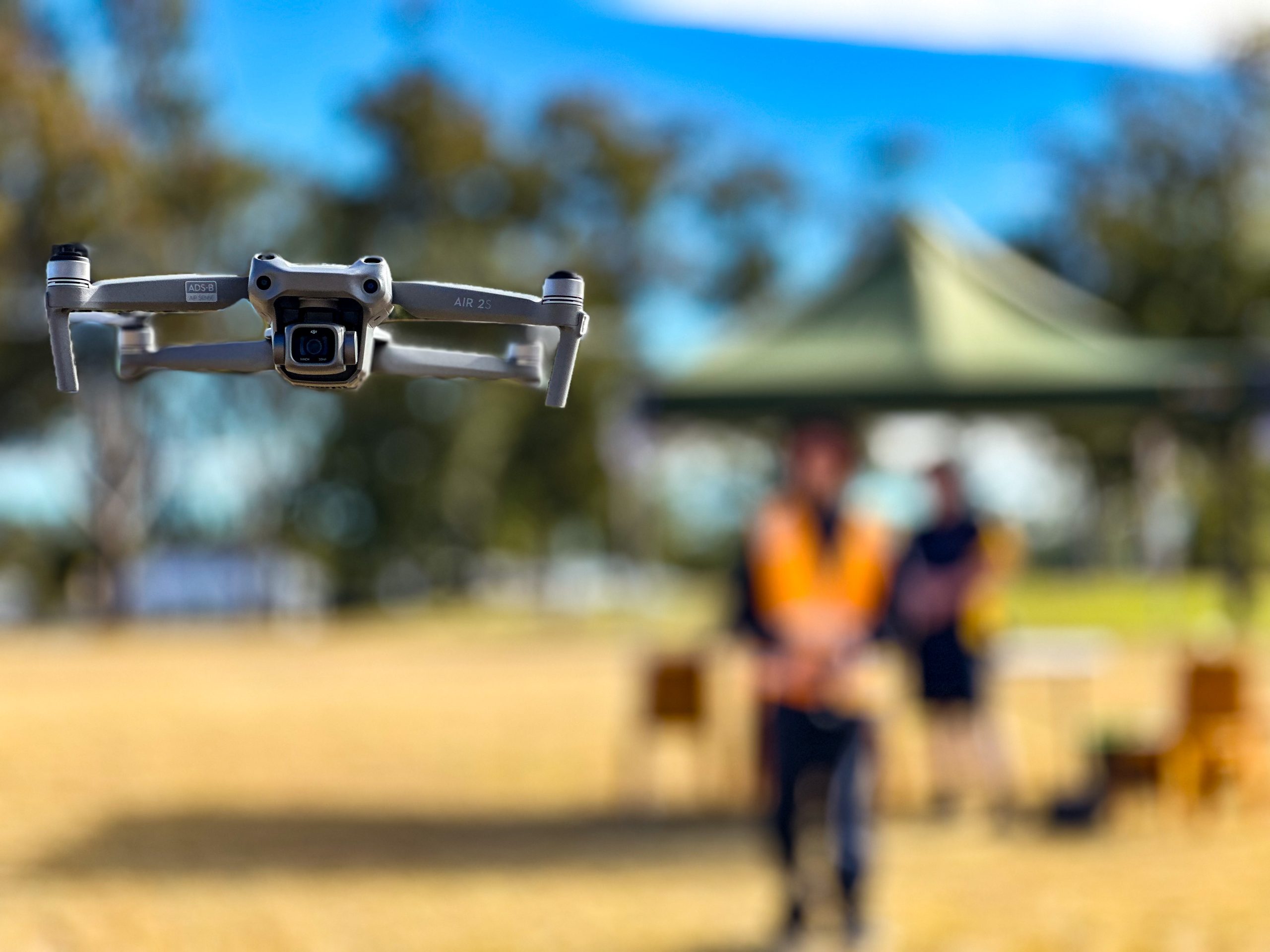 Students flying a DJI Air 2s being flown in an open field