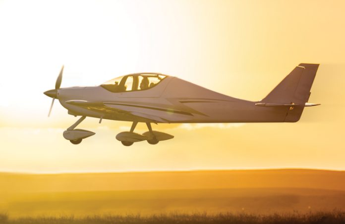 Small plane flying during sunset