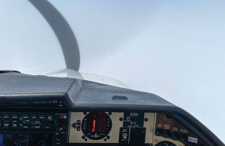 Inside a cockpit looking out the window of fog. There is zero visibility through the fog.