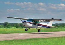 Photo of small aircraft taking off from a runway