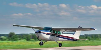 Photo of small aircraft taking off from a runway