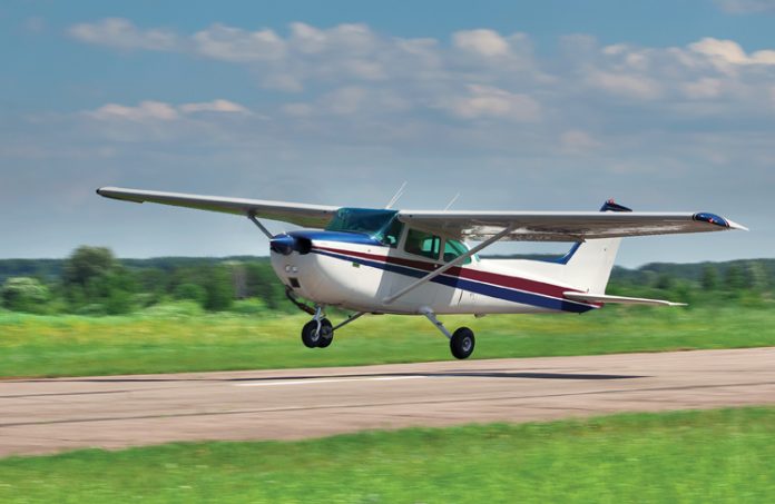 Photo of small aircraft taking off from a runway